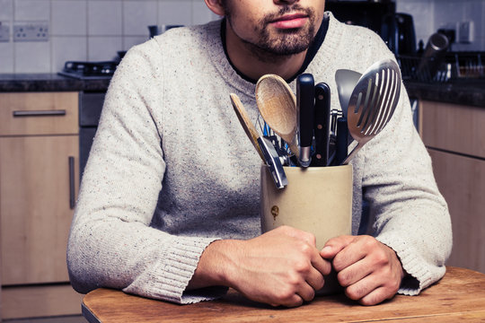 Man with kitchen utensils