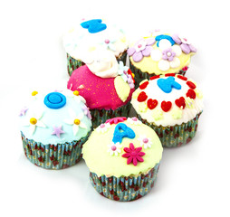 Cupcakes with spring flowers on white isolated background