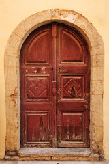 Fototapeta na wymiar Old wooden door in city of Rethymno, Crete, Greece