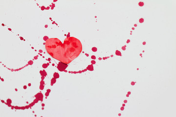 Paper heart and red splashes