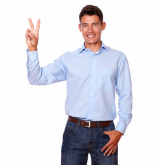 Naklejka premium Smiling man is standing with a victory sign.