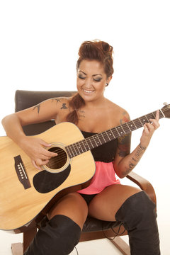 woman tattoos guitar look down