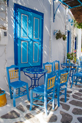 Traditional greek chairs in small backstreet - obrazy, fototapety, plakaty