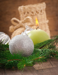 Christmas card with Christmas balls and a burning candle