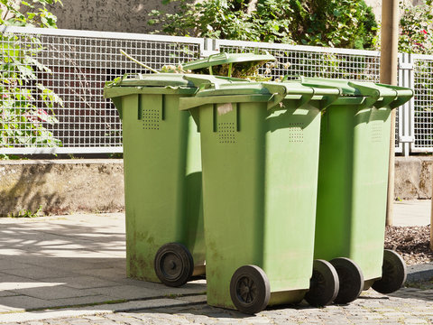 Gr&uuml;ne M&uuml;lltonnen f&uuml;r Bioabfall stehen am Strassenrand