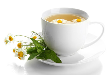 Cup of herbal tea with wild camomiles and mint, isolated