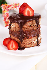 Chocolate cake with strawberry on wooden table close-up