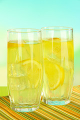 Delicious lemonade on table on light blue background