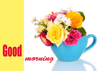 Beautiful bouquet of bright flowers in color mug, isolated