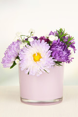 Beautiful bouquet of bright flowers in glass vase,