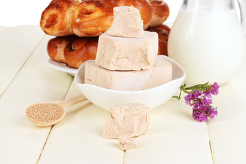 Dry yeast with pastry on wooden table close-up