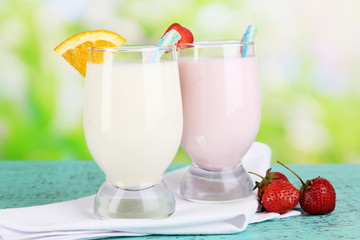 Delicious milk shakes with orange and strawberries