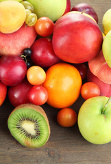 Assortment of juicy fruits, on wooden background