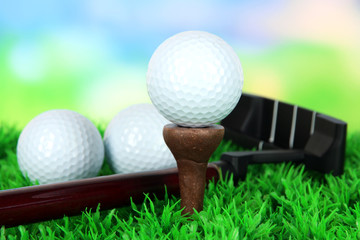 Golf ball and driver on green grass outdoor close up