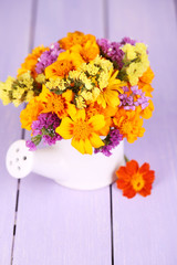 Bouquet of marigold flowers in watering can