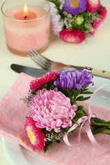 Obraz na płótnie Canvas Festive dining table setting with flowers