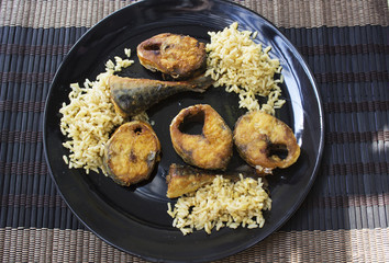 roasted mackerel fish with rice on wicker mat