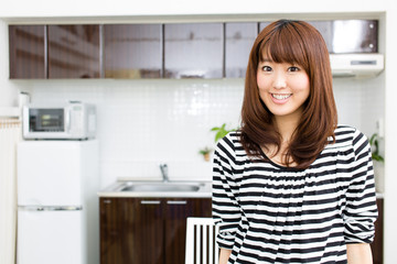 young asian woman relaxing in the kitchen