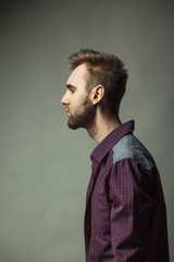 Young adult man on a dark background