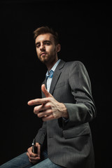 Young businessman on a dark background