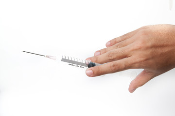Hand holding syringe