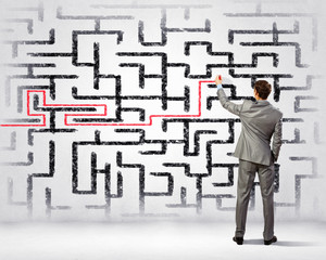 Businessman solving labyrinth problem