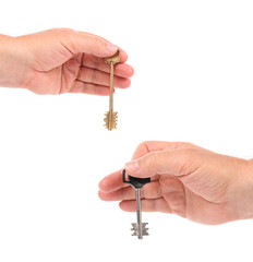 Hands holds modern steel-plastic and bronze key.