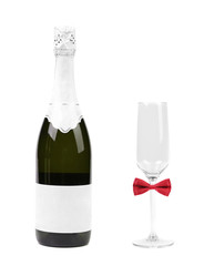 Glass with red bow tie and bottle of champagne.