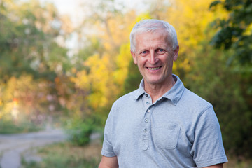 portrait of happy smiling face of grey-haired old man