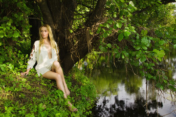 Pretty woman on the forest lake