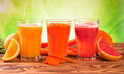Fresh fruits, vegetables and juice on wood