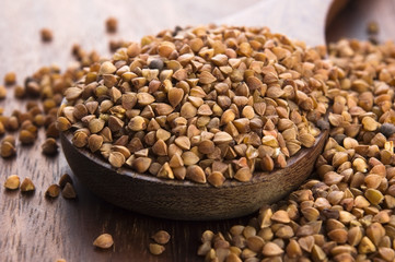 Buckwheat seeds on wooden spoon in closeup