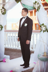 Groom at wedding ceremony