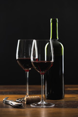 Fototapeta na wymiar Two glasses of red wine and bottle