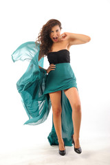 Naklejka premium Girl dancing with long green dress isolated white background