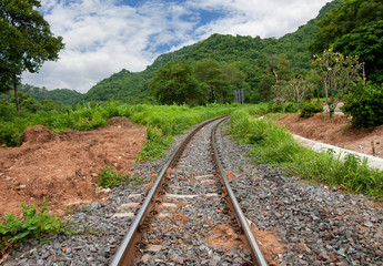 Fototapeta na wymiar Train tracks curving along a mountain