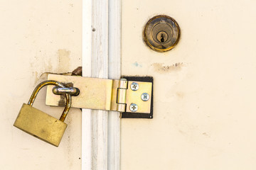 Old key lock on white door