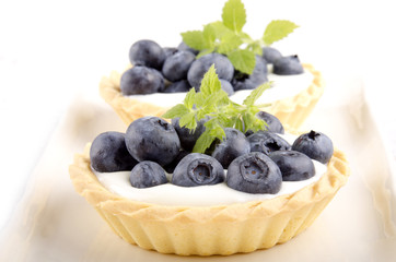 blueberries with mint in a pastry case