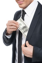 Bribe. Close-up of businessman taking bribe while isolated on wh