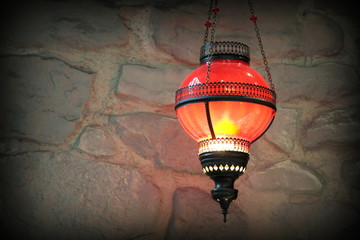 Obraz premium Metal lantern on a old stone wall