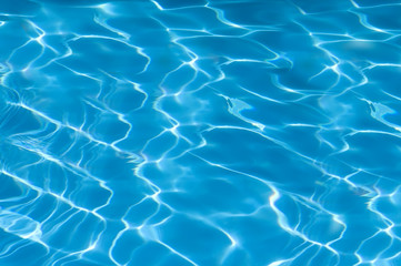 Fototapeta na wymiar beautiful clear pool water reflecting in the sun background