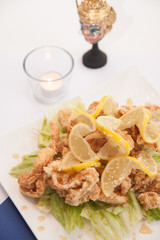 Deep fried chicken with honey and lemon sauce.