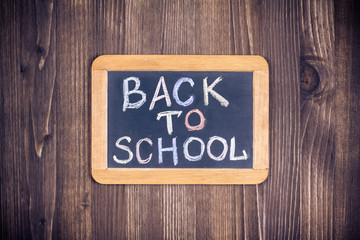 Back to school blackboard banner on wood wall background