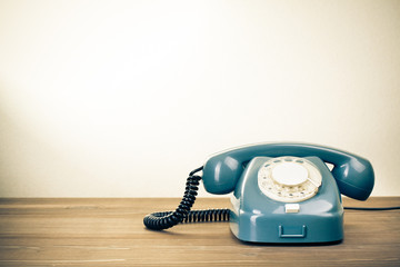 Retro background with rotary telephone on wood table