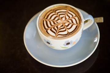 coffee cup on brown table