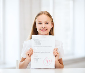 girl with test and grade at school