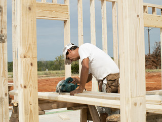 Framer sawing piece of lumber