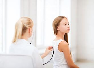 Fototapeta premium doctor with stethoscope listening to the patient