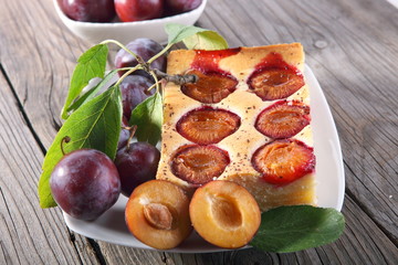 Plum cake over natural wood background 
