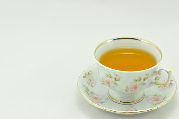 porcelain tea cup full of tea  on a white background
